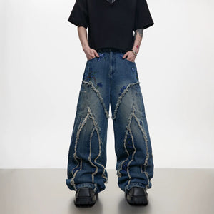 Front view of blue baggy jeans with sequin embroidery and distressed details.