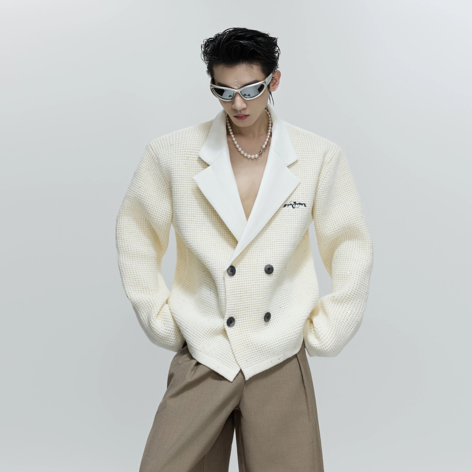 Front view of the sequin double-breasted knit blazer in black color.