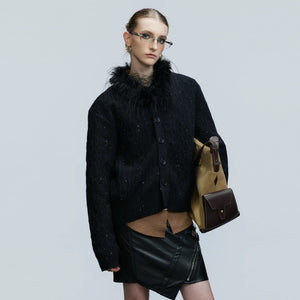 Model wearing sequin fur collar cardigan with baggy jeans in street setting