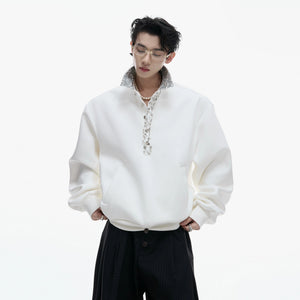 Close-up of the unique safety pin design on the polo collar