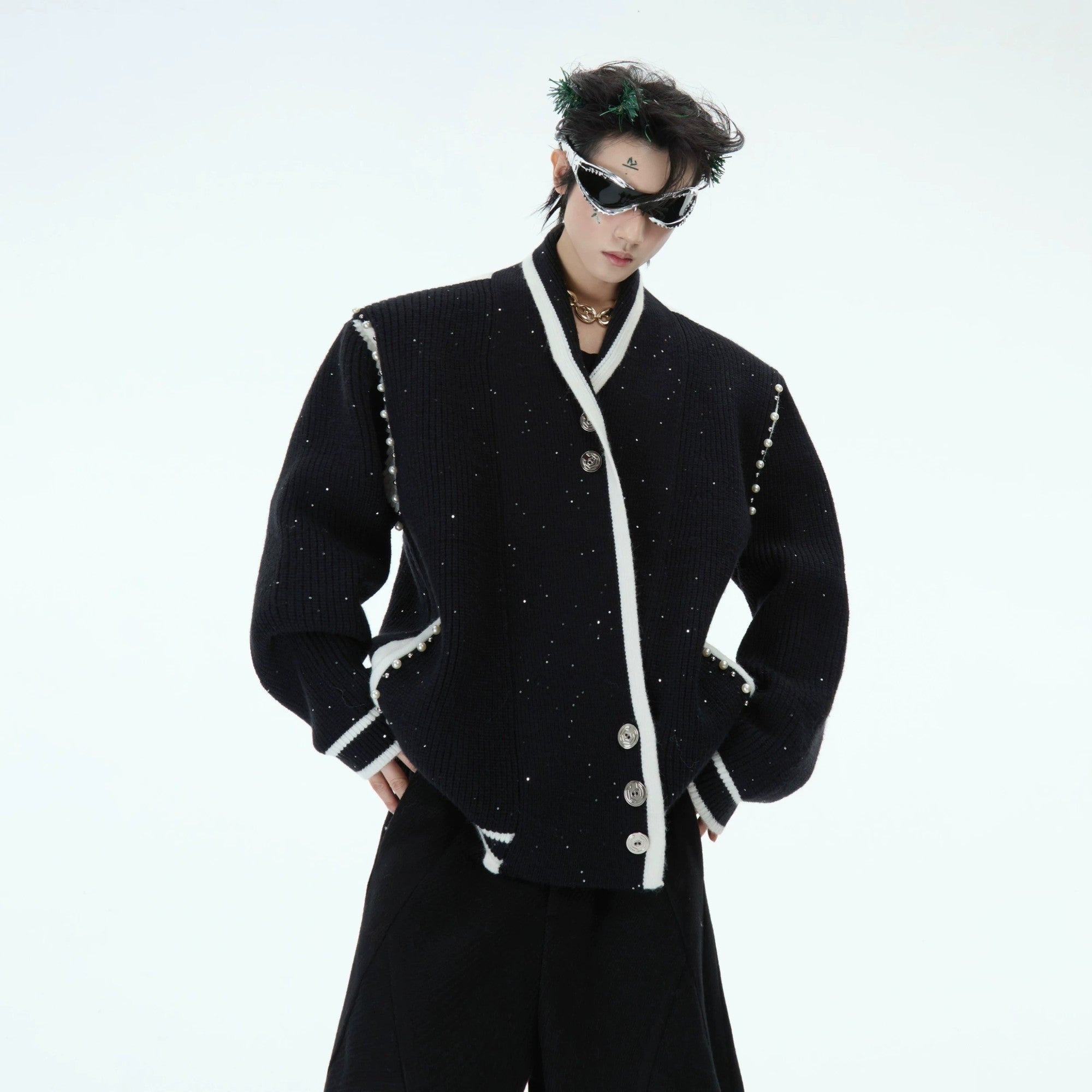 Front view of the deconstructed shimmer knit cardigan in black with contrast piping