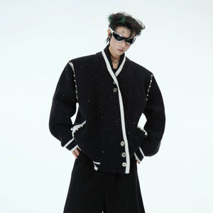 Front view of the deconstructed shimmer knit cardigan in black with contrast piping