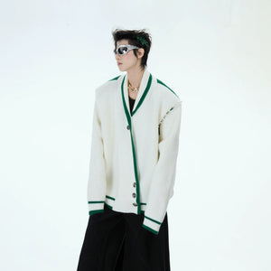 Side view of the white deconstructed knit cardigan showing the loose fit