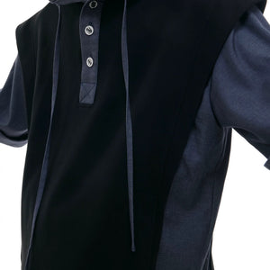 Model wearing patchwork hoodie set in an urban street setting