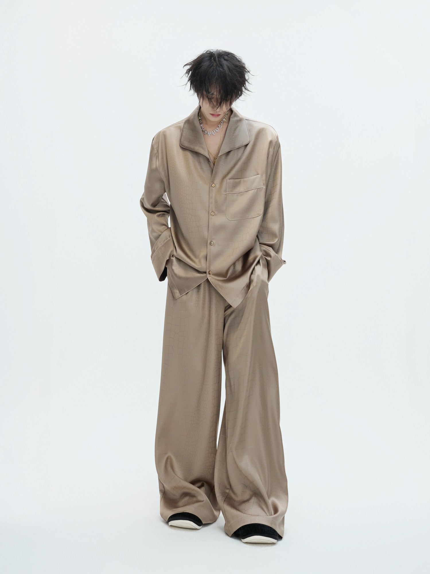 Model wearing black silky acetate lounge set in a streetwear style