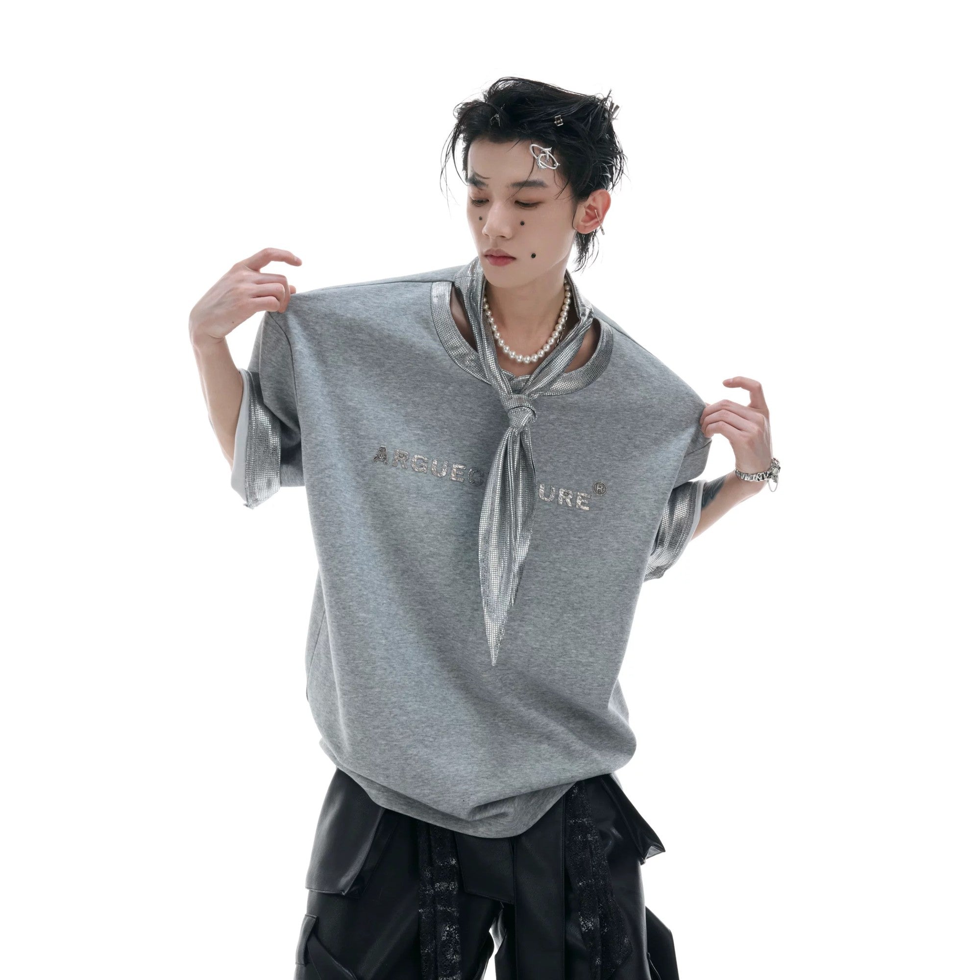 Black oversized streetwear t-shirt with silver ribbon tie and metallic graphic.