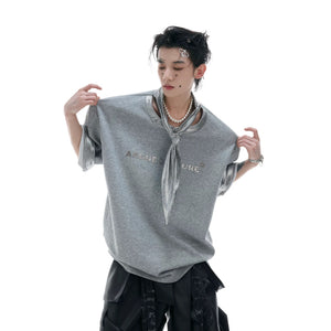 Black oversized streetwear t-shirt with silver ribbon tie and metallic graphic.