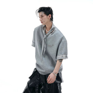 Close-up of the shiny silver ribbon and deconstructed neckline detail.