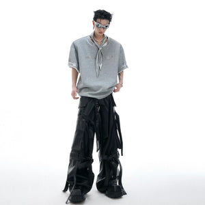 Model wearing the metallic tie graphic tee in an urban street setting.