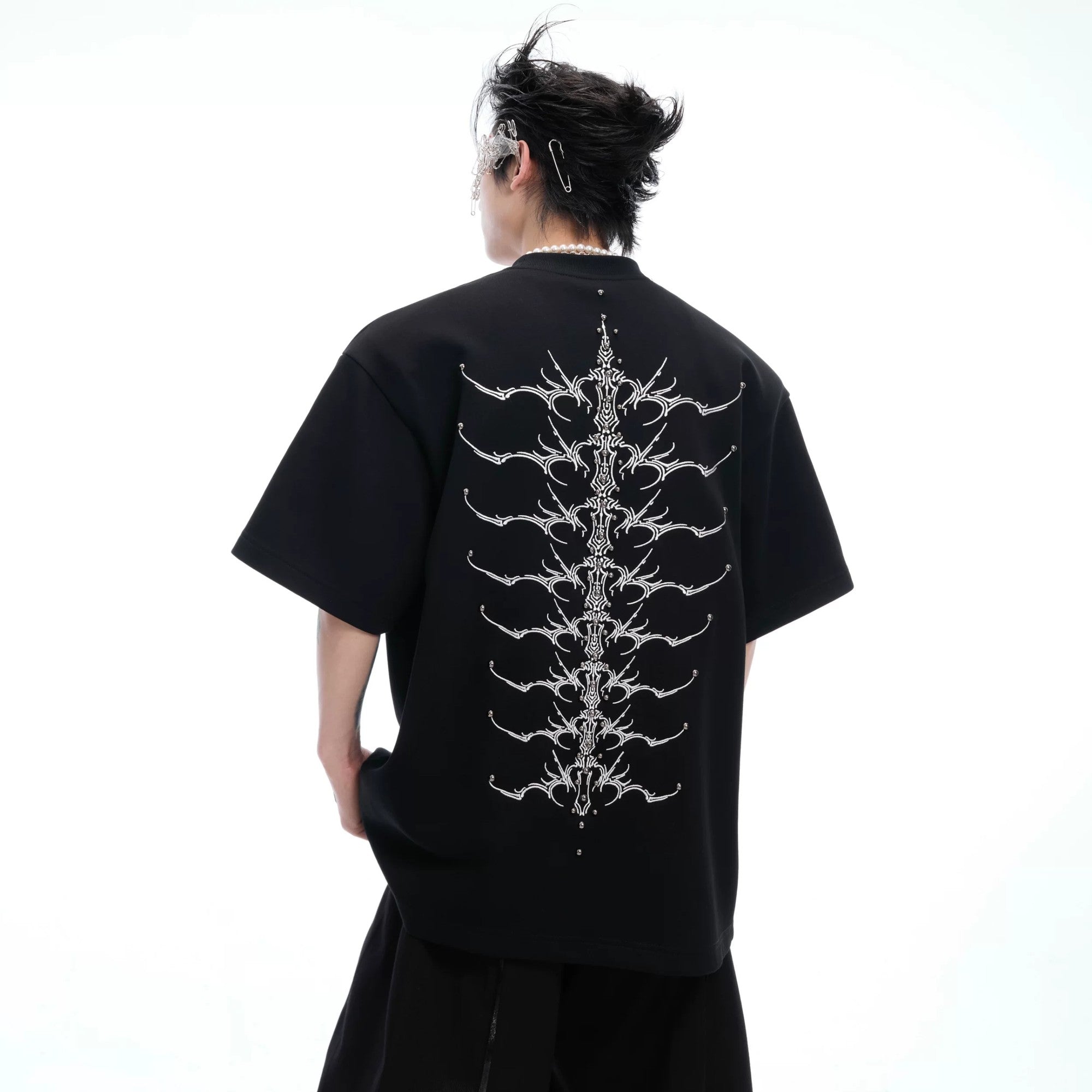 Front view of white oversized cotton T-shirt with designer metallic logo