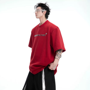 Close-up of intricate 3D spine embroidery and beadwork on back of tee