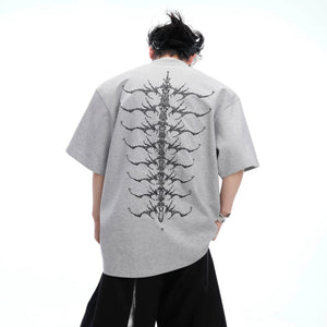 Model wearing gray oversized spine embroidered streetwear T-shirt