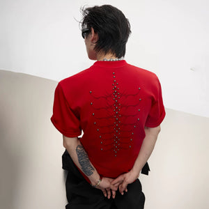 Close-up of the hand-embroidered spine and metal studs on the back