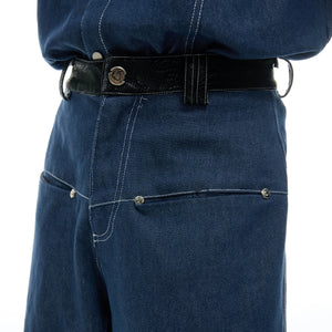 Model wearing the oversized blue denim snake skin set in a street setting