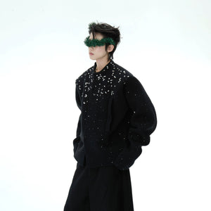 Close up of manual rhinestone work on a red shimmer knit jacket