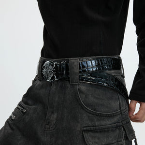 Close-up of black glossy crocodile embossed leather and titanium buckle.