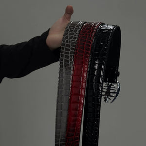 Top view of three colors of spine buckle crocodile texture leather belts.