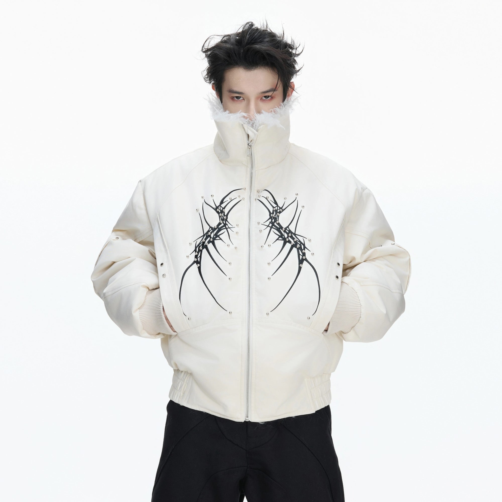 Detailed spine embroidery on the back of a black streetwear jacket