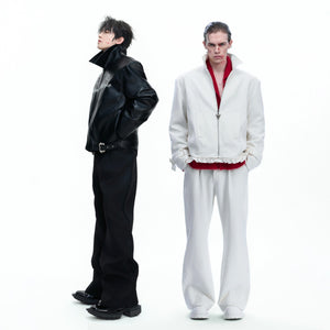 Lifestyle shot of white deconstructed trousers paired with a vintage tee