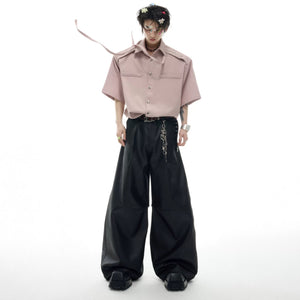 Model wearing a relaxed fit streamer shirt in a city street setting