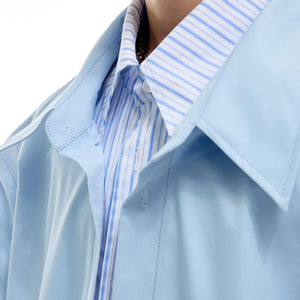 Close-up of polished hardware beads on the double-layer lapel collar.