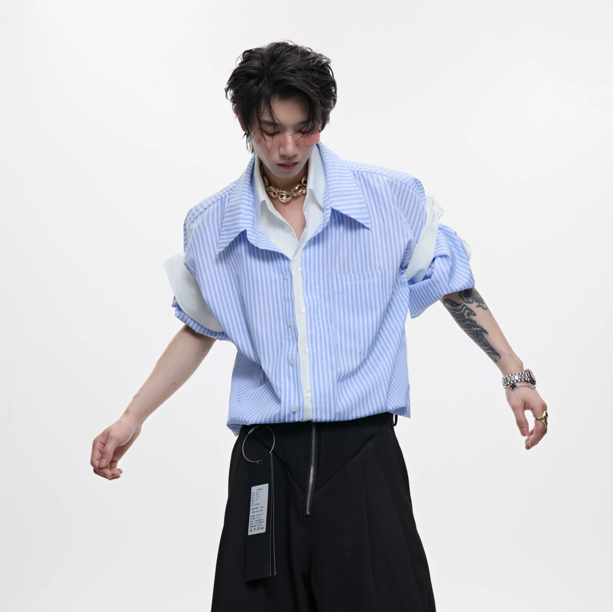 Front view of a men's blue striped faux two-piece short sleeve shirt in a loose fit.