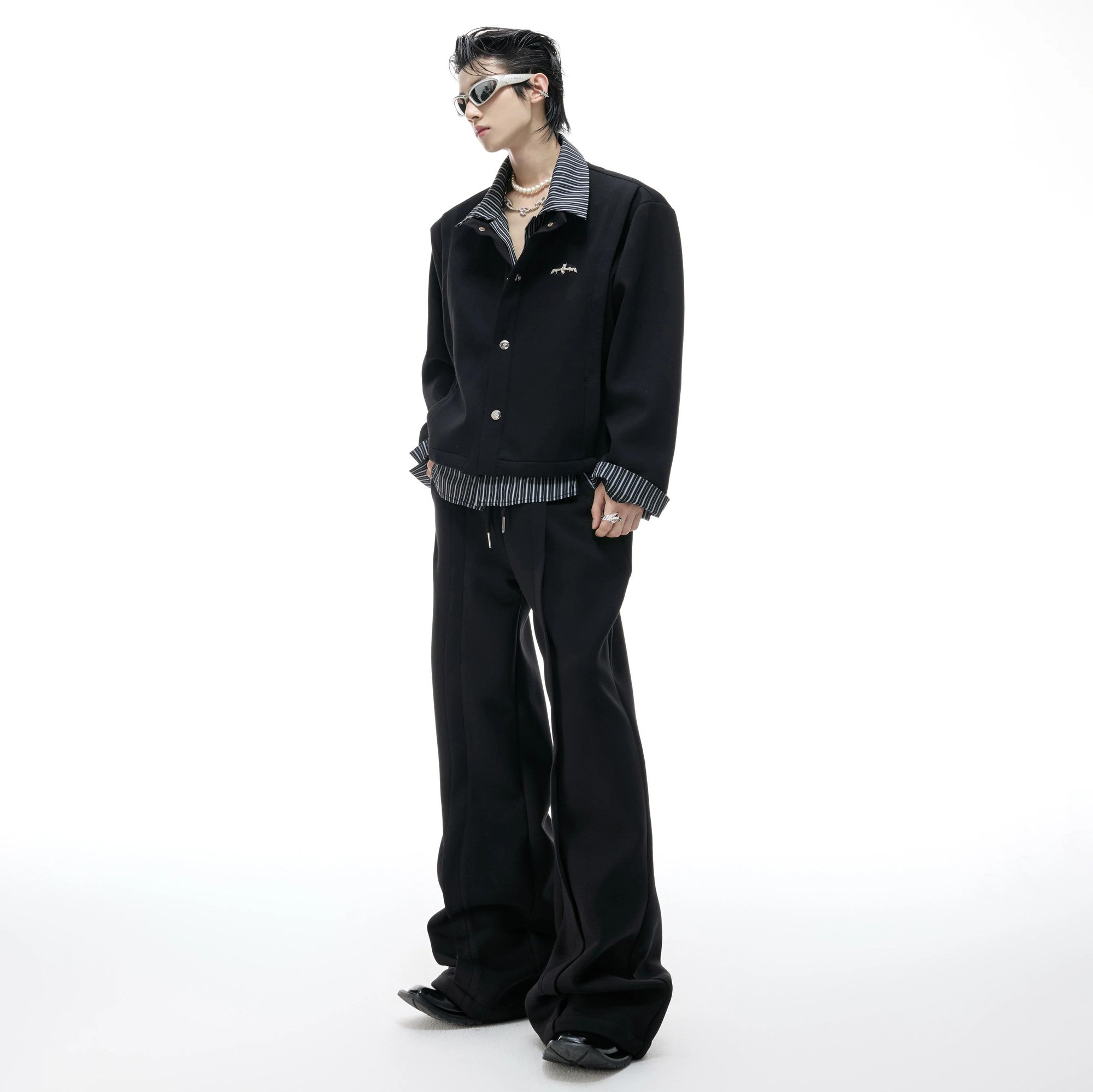 Model wearing gray striped faux two-piece sweatshirt set in street setting