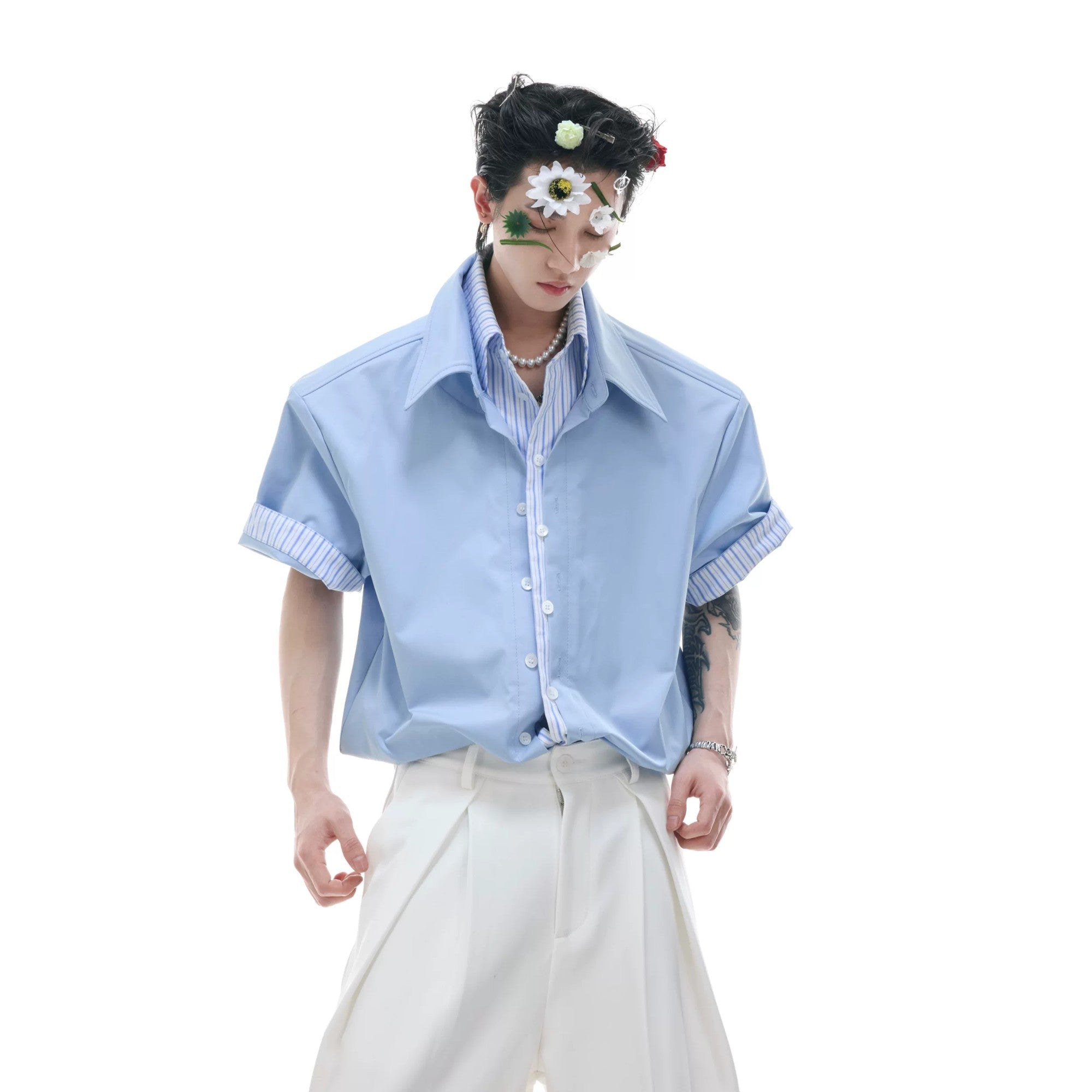 Front view of a loose striped fake two-piece short sleeve shirt in white