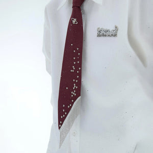 Close up of irregular pearls and polished hardware on a streetwear tie.