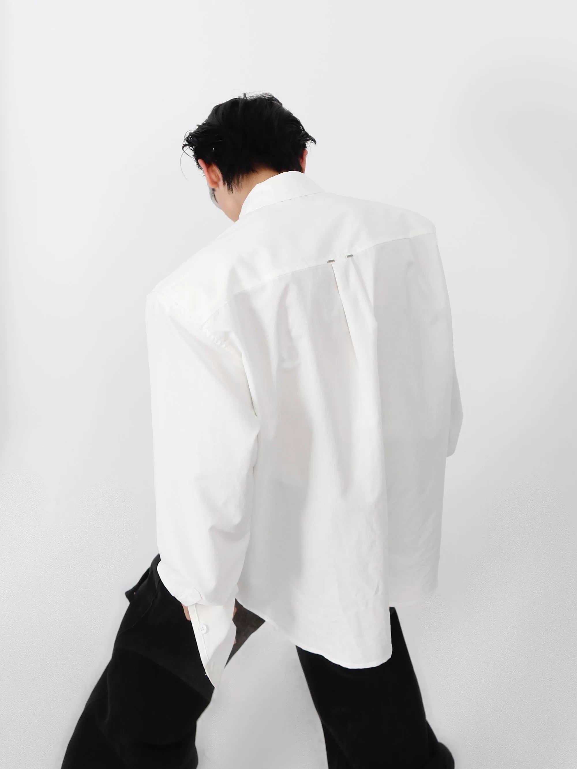 White avant-garde cropped shirt with metal studs side profile