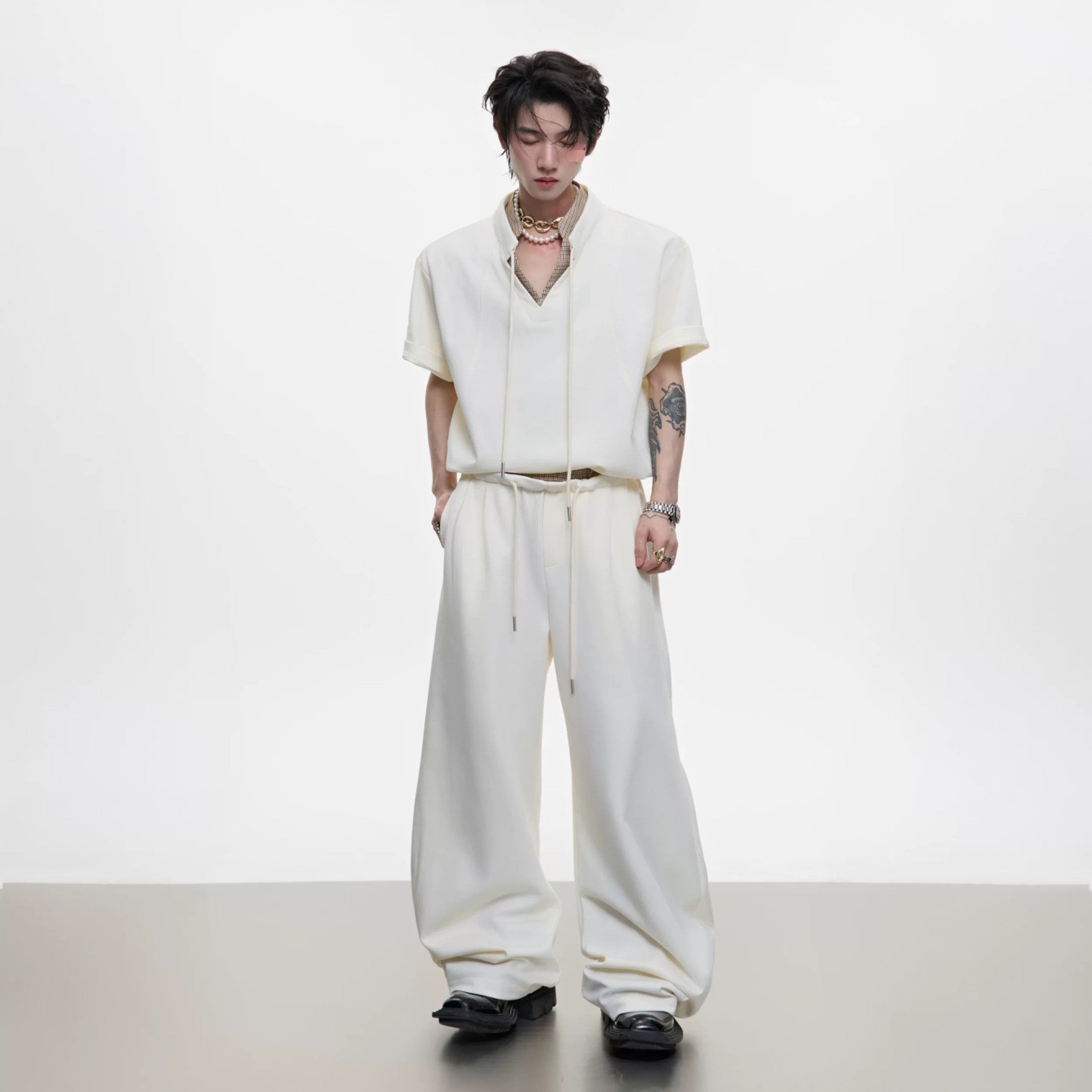 Model wearing apricot houndstooth short sleeve set with curved pants