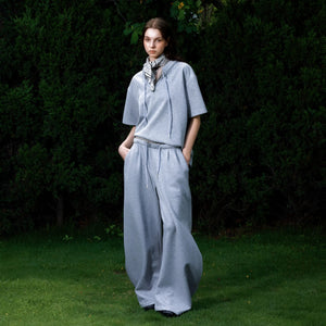 Close up of the double waistband and curved leg design on gray sweatpants