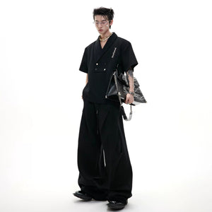 Gray deconstructed co-ord set featuring pleated details and shoulder pads