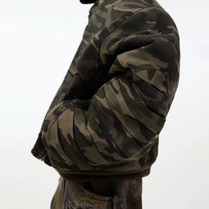 Full body look of a loose fit retro camo bomber jacket styling