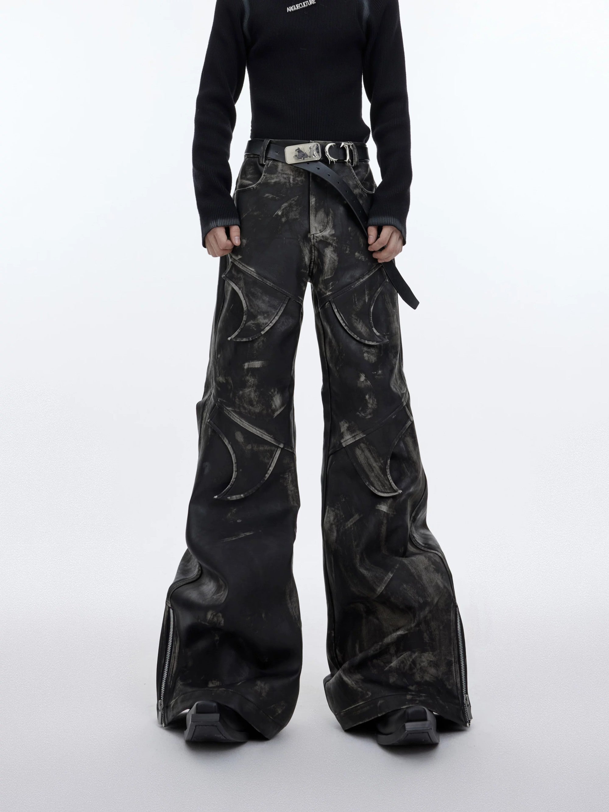 Front view of men's distressed deconstructed flared leather pants in black.