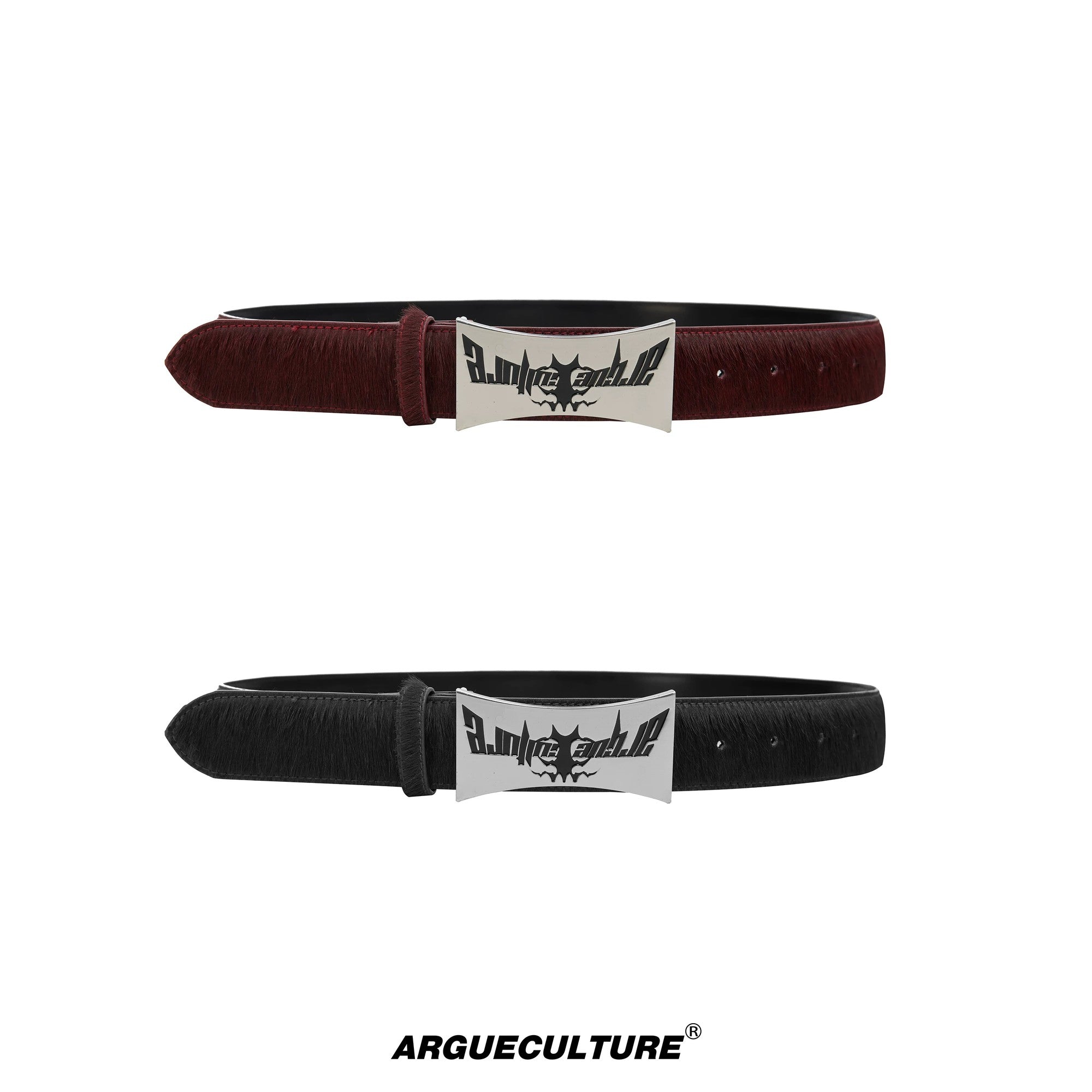 Close up of a black horsehair leather belt with a distressed metal plaque.