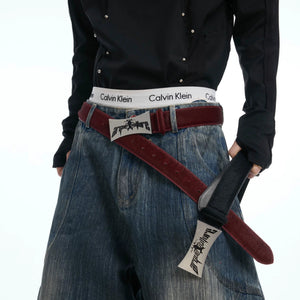 Detailed shot of the vintage titanium buckle on a genuine leather strap.