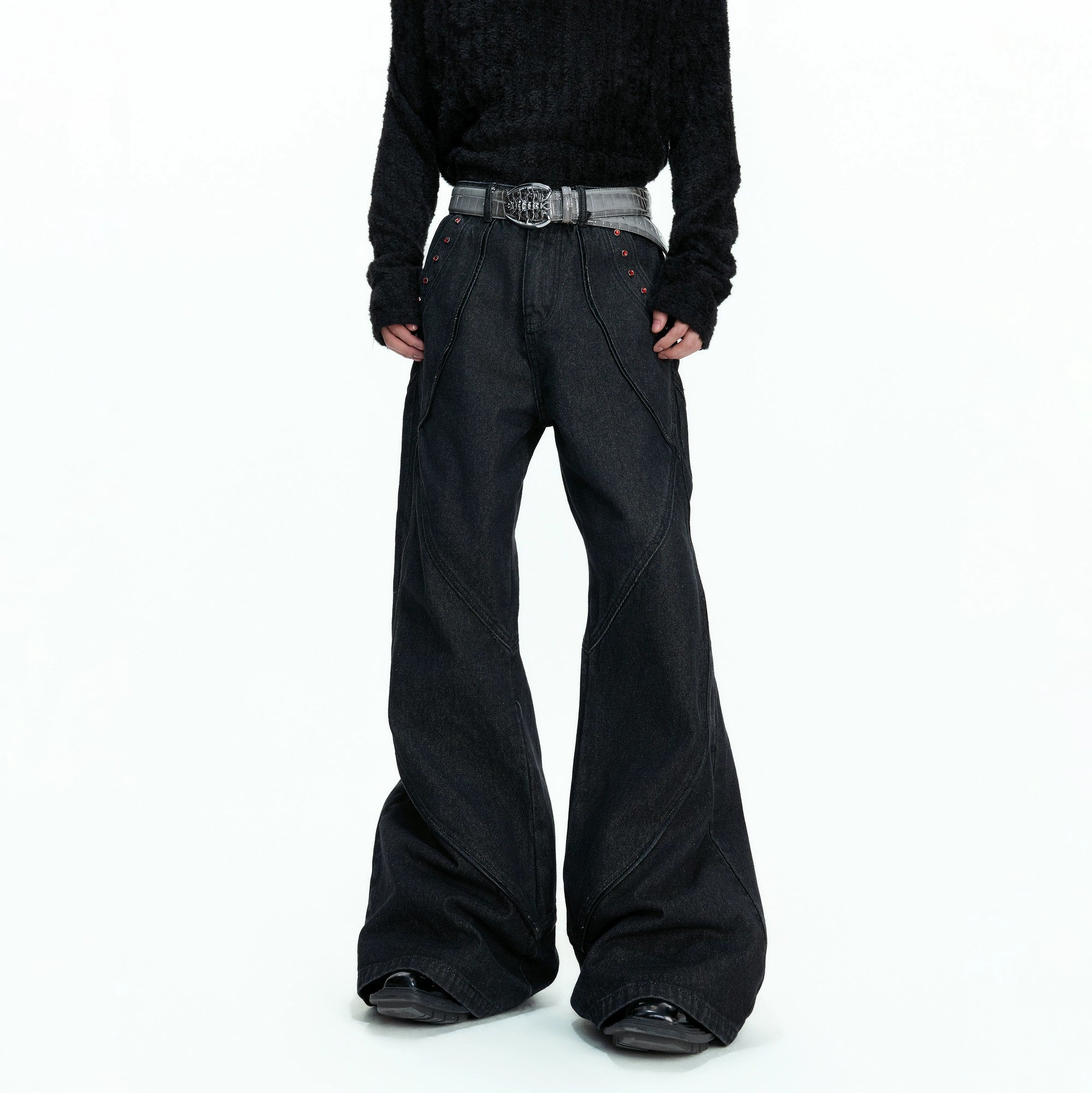 Front view of vintage distressed black flare denim with red rhinestone details