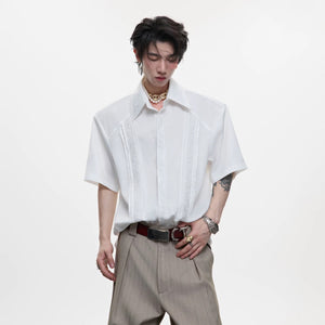 Front view of white vintage embroidered streetwear shirt with shoulder pads