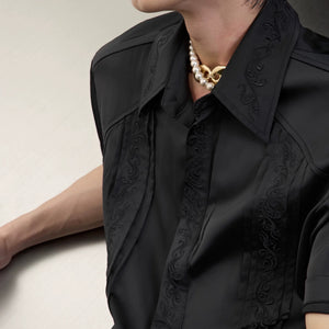 Model wearing vintage embroidered shirt in a street style setting