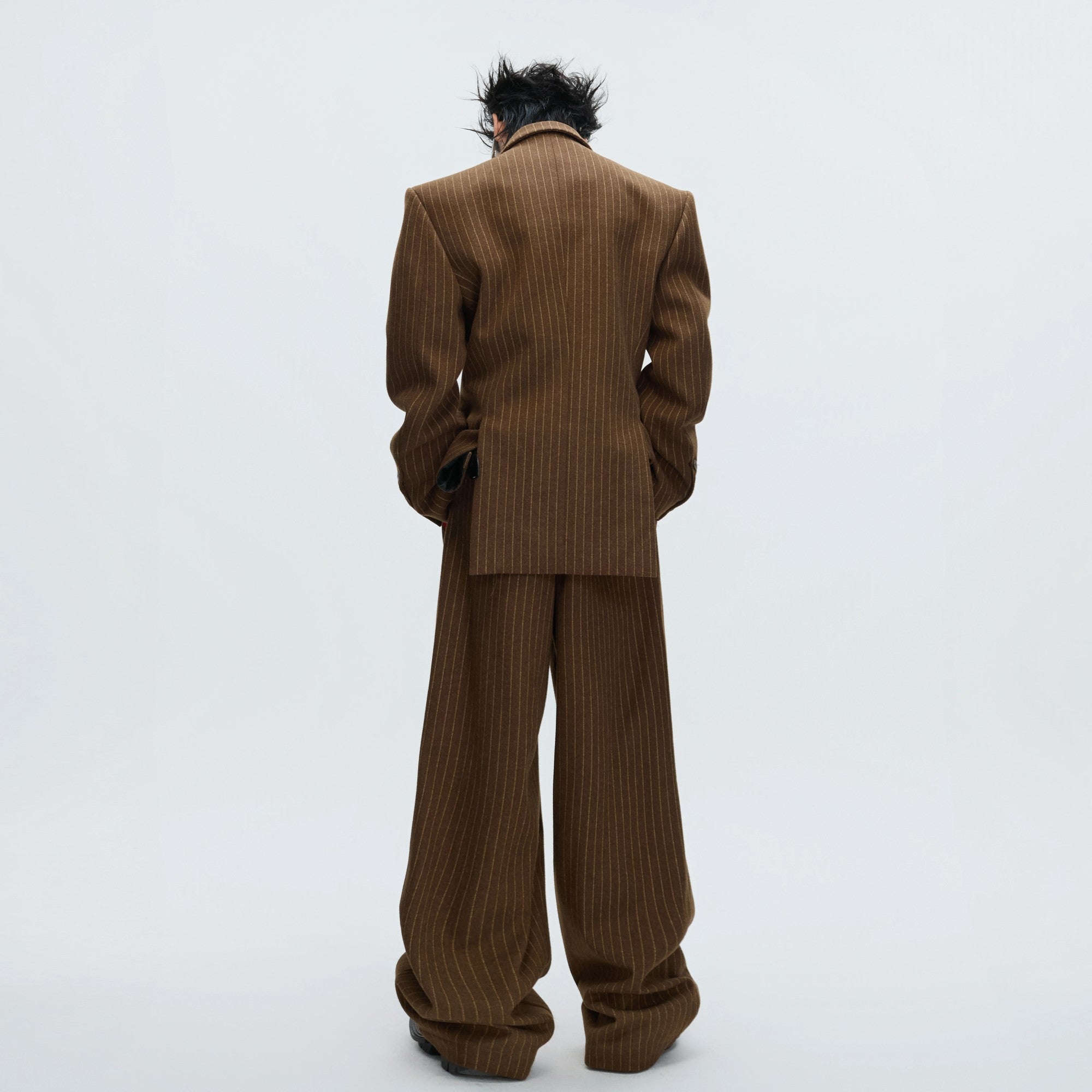 Close-up of lava-inspired splicing and metal details on a brown blazer