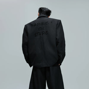 Back view of the oversized blazer showing the back vent design