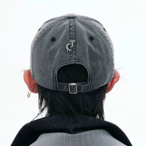 Back view of adjustable strap on a distressed gray dad hat