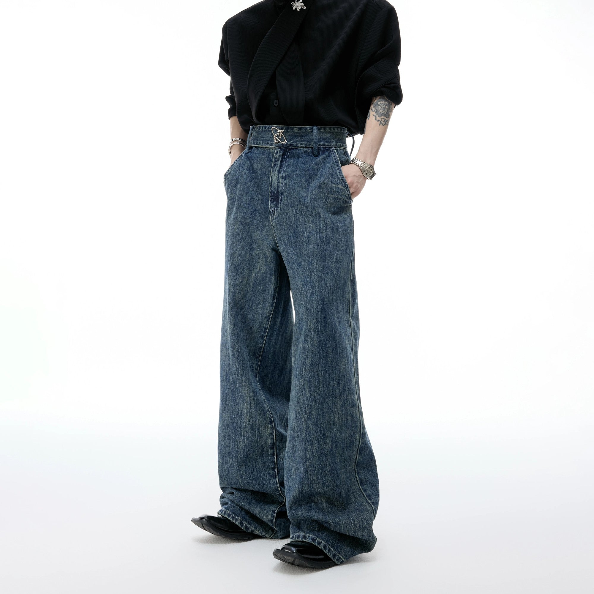 Front view of baggy washed wide-leg distressed denim jeans in blue