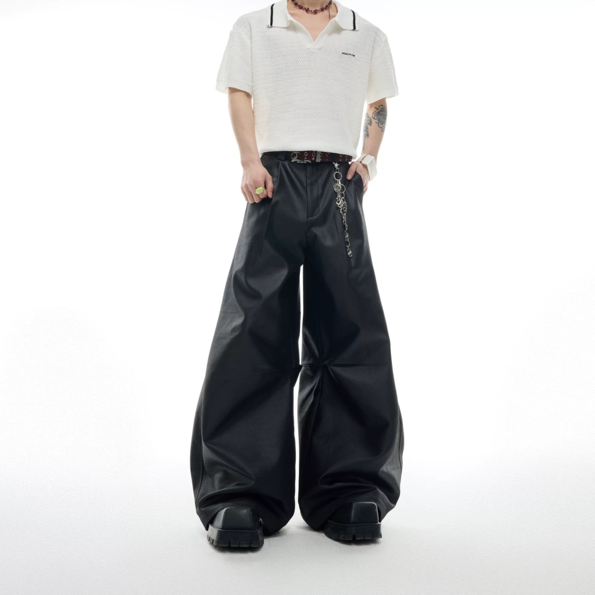 Front view of black metallic waxed wide-leg streetwear trousers