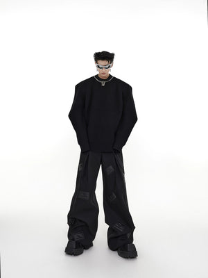 Back view of the loose fit silhouette of the 3D leather patch pants