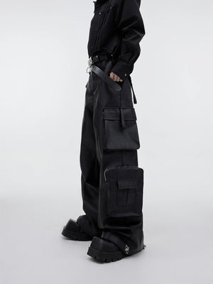 Front view of black wide-leg PU leather cargo pants with 3D pockets