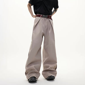 Side profile of khaki luxury drape streetwear pants showing embroidery.