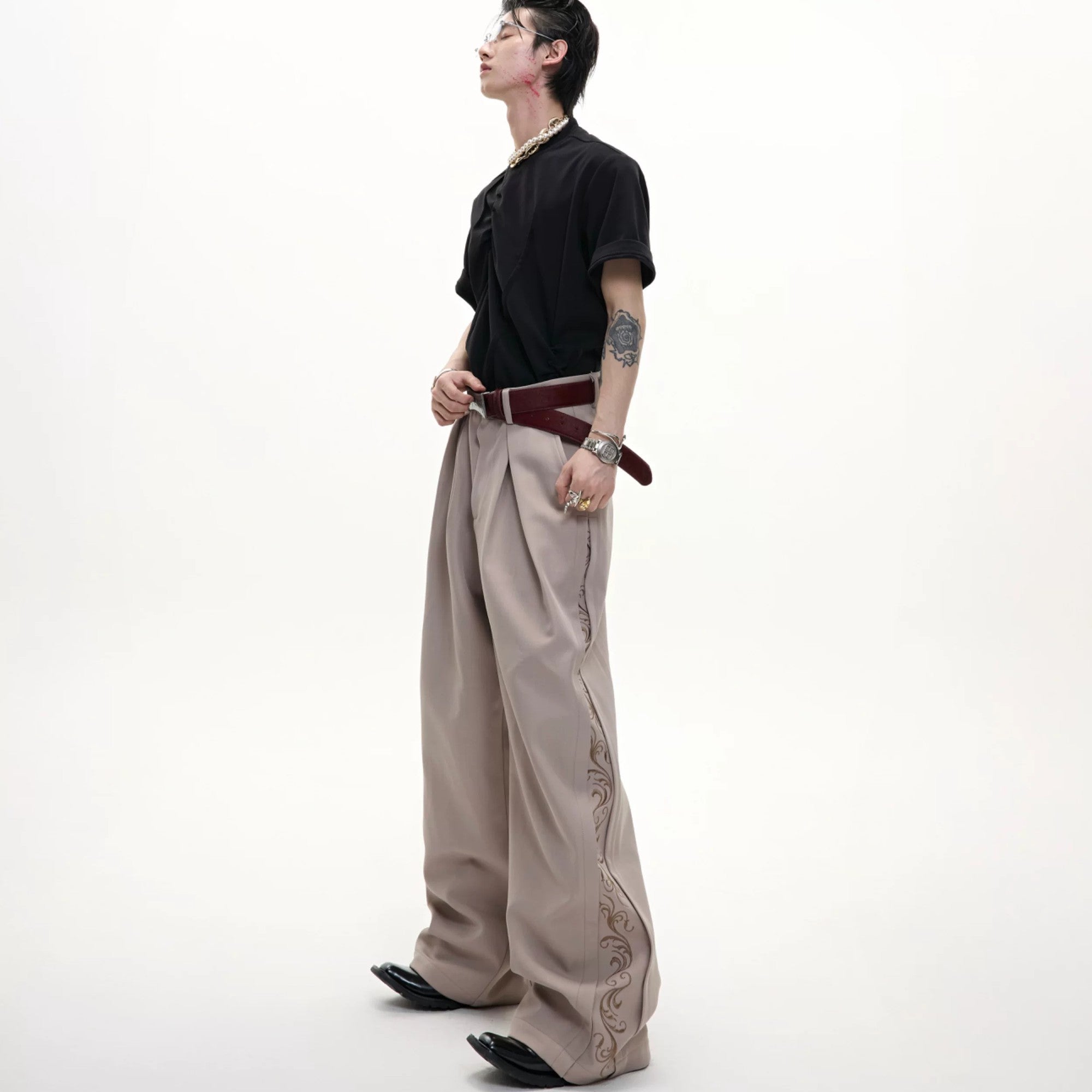 Back view of black vintage pleated wide-leg trousers.