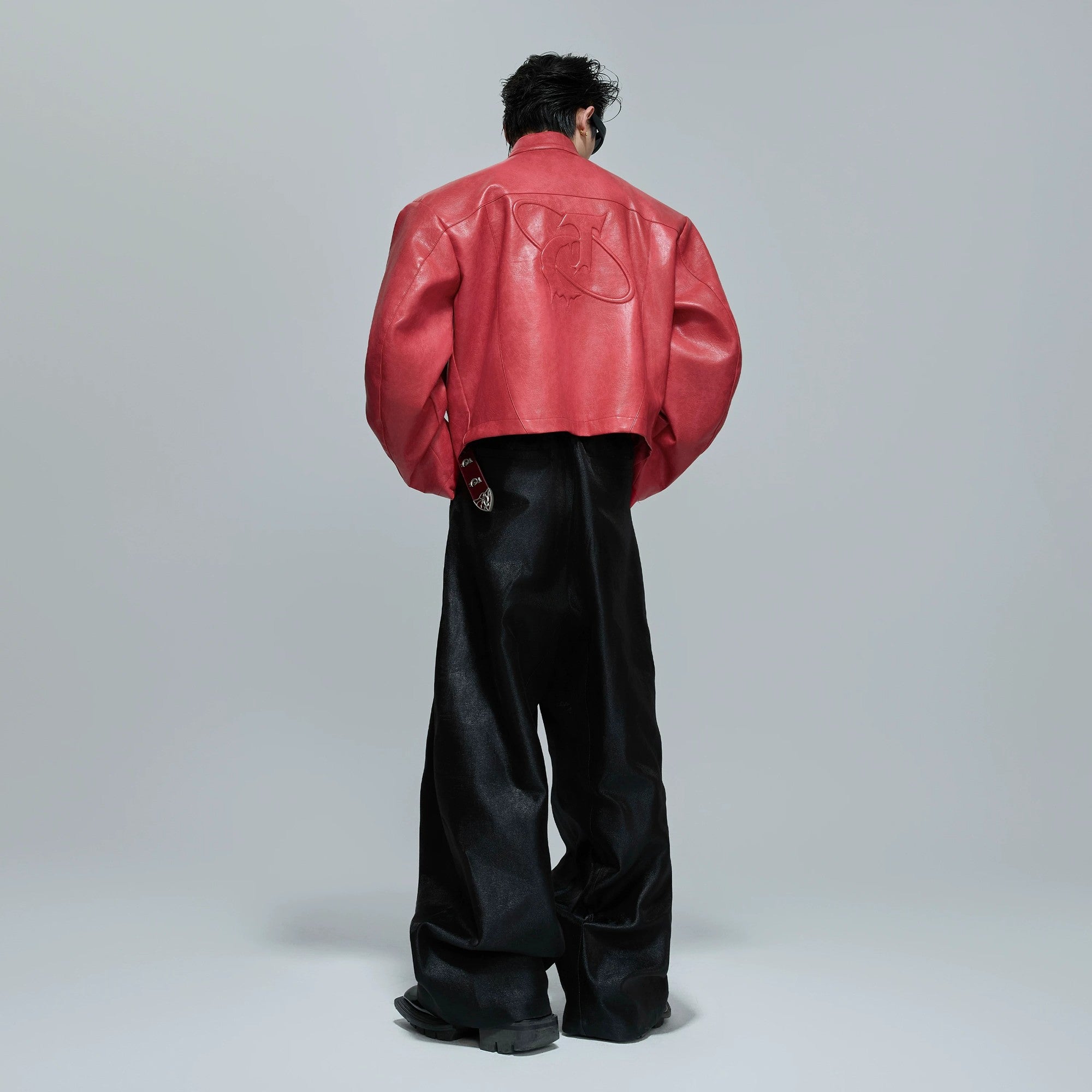 Model wearing oversized armor moto jacket in urban setting